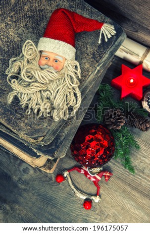 vintage christmas decoration with antique handmade toys and Santa Claus on wooden background. retro style toned picture. selective focus