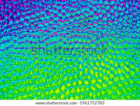 Background . Colored patterned glass. Blurred abstract pattern. Rainbow. Ripples.