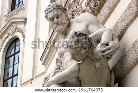 A statue depicting the ancient Greek hero Hercules and his exploits. Sculpture on the facade of a historic old building in Vienna.