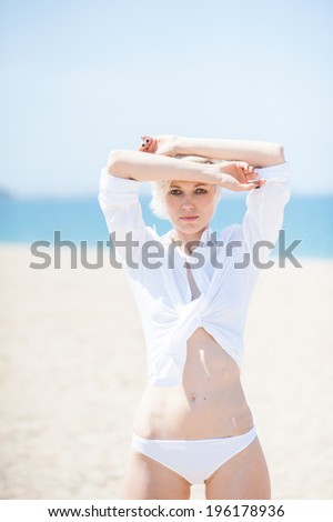 woman in white clothing on the beach