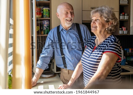 Senior couple together in their kitchen at home
