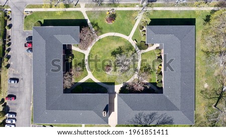 A top-down shot over a residential building. It was taken on a sunny morning and the area is quiet and peaceful.