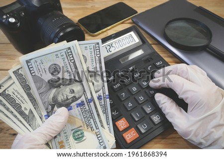 calculator, digital camera and money, store selling photographic equipment, pawnshop, closeup