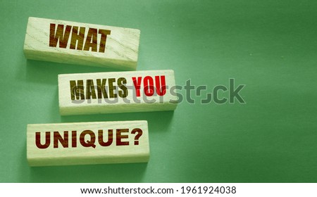 What makes you unique - phrase on Wooden blocks. Business or carees success concept.