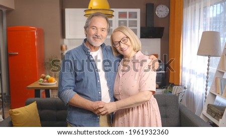 Loving elderly husband and wife are hugging each other and holding hands. Love concept at all ages.