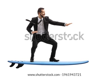 Full length profile shot of a businessman riding a surfboard isolated on white background 