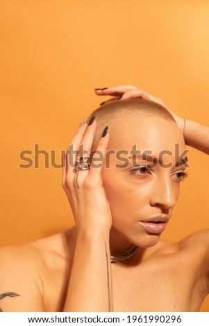 Woman posing fashionably with hands near her face and serious emotions