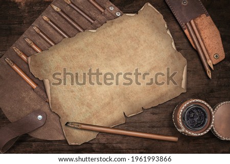 calligraphy mockup, Top view of inkwell, Leather pen Case , and calligraphy pens on Old blank message with space for Your own writing