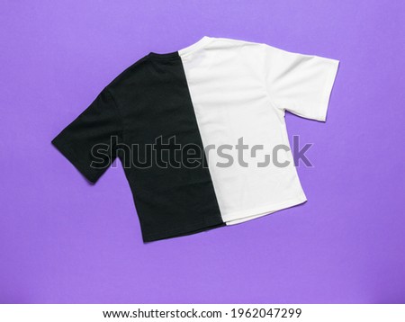 Stylish black and white T-shirt on a purple background. Summer clothing.
