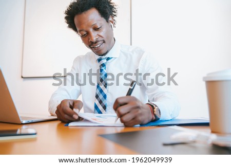 Afro American Businessman working at office.