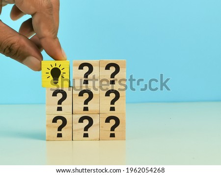 Wooden cubes with light bulb and question mark symbol. Question mark concept. 