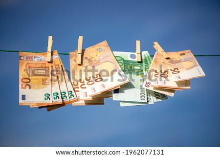 100 and 50 euro banknotes drying. Washed Euro paper bills. Drying euro on a string.Money laundering Royalty-Free Stock Photo #1962077131