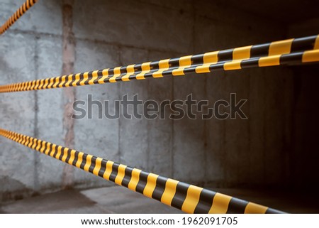 Barrier tape stretched at the entrance to the parking