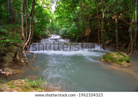 scenery of waterfall in the jungle with the rock at the below left of the picture from kanchanaburi, thailand