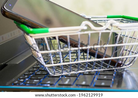 online shopping concept shopping cart on the laptop keyboard in the shopping cart smartphone. High quality photo