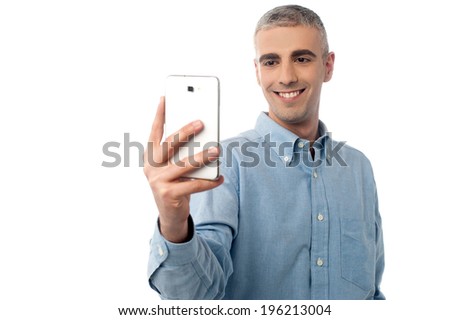 Handsome man taking a picture with his phone