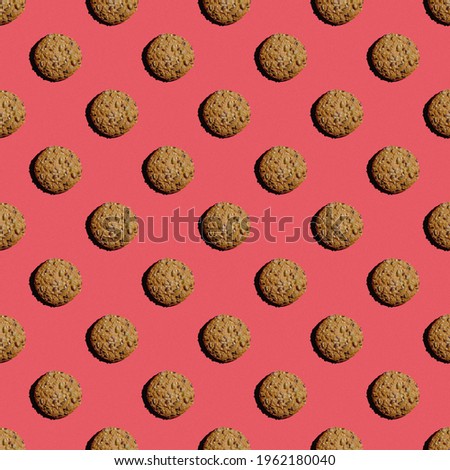 Seamless pattern of cookies pictures with seeds on a pink background. Wallpaper with cookies. Good to use for wallpaper, textile, background, poster, cover, postcards.