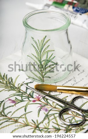  Decorative decoupage vase with rosemary branch painting and scissors, brush on the paper with rosemary picture