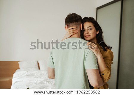 Happy young couple is hugging and showing their feelings, close up. Young family moving to new apartment