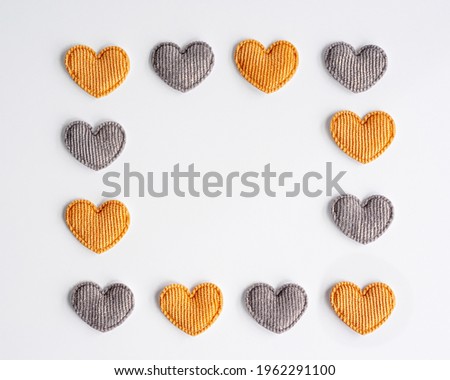 Rectangular frame made from small yellow and grey striped textile hearts