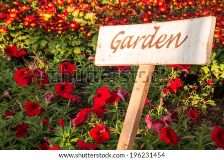 Garden sign on weathered wooden plate