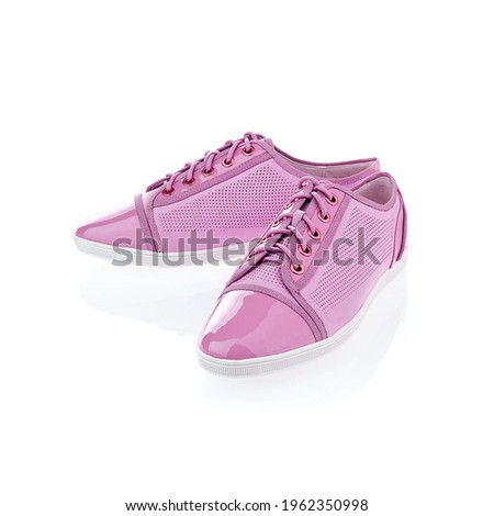 Pair of pink stylish sneakers isolated on white background