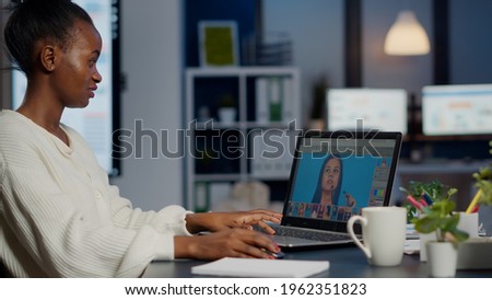 Black woman photo retoucher working on laptop at new project in business office overtime. Content creator doing portrait retouching, artist, occupation, screen, graphic late at night