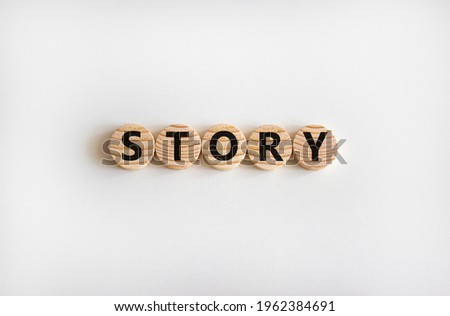 Story symbol. The word 'story' on wooden circles on white table. Beautiful white background, copy space. Business and story concept.