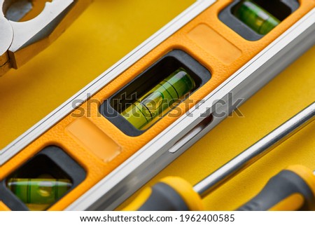 Workshop instrument closeup, yellow background