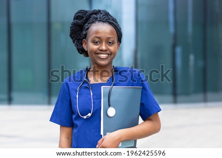 smart black girl medical student, happy young african american woman doctor, nurse in blue uniform, stethoscope, smiling afro female at university, college, hospital, clinic. copy space Royalty-Free Stock Photo #1962425596