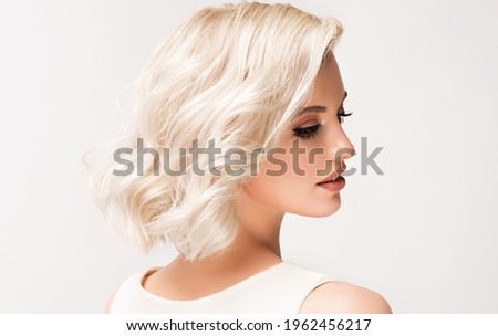 Beautiful model girl with short hair .Beauty  smiling woman with blonde curly hairstyle dye .Fashion, cosmetics and makeup