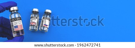 American COVID-19 vaccine concept, doctor in blue gloves, race of development and manufacture vaccine for vaccination, banner with copy space photo