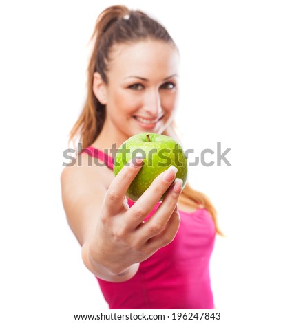 portrait of a pretty young woman wearing a sport clothes and showing an apple