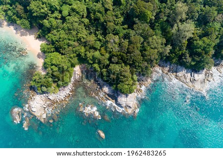 High angle view Tropical sea with wave crashing on seashore and high mountain located in Phuket Thailand aerial view drone top down Amazing nature view landscape.