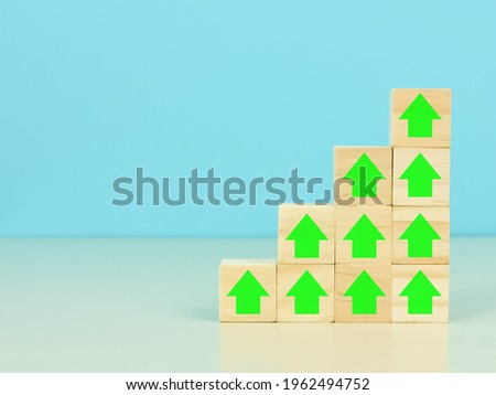 Business growth process concept. Wooden cubes with percentage and arrow icons stacking as stairs upward direction.