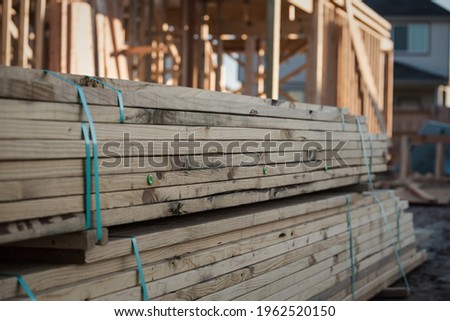 A pile of lumber at a new home construction site. Royalty-Free Stock Photo #1962520150