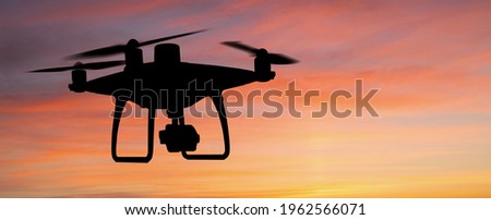 Silhouette of a drone on a sunset background	