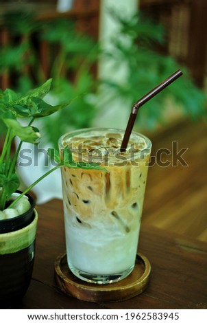 Iced coffee on a wooden table in a cafe.