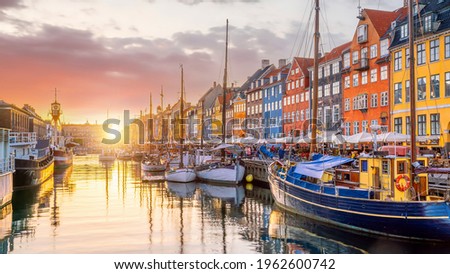 Cityscape of downtown Copenhagen city skyline in Denmark at famous old Nyhavn port at sunset Royalty-Free Stock Photo #1962600742