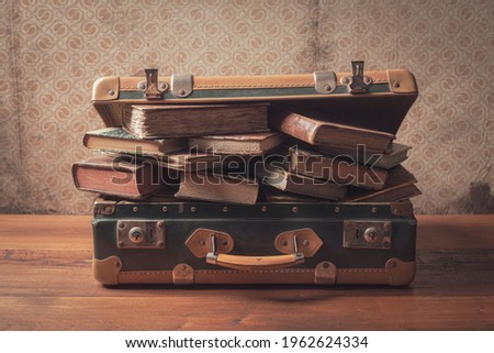 Old suitcase full of vintage books and novels, reading and travel concept Royalty-Free Stock Photo #1962624334