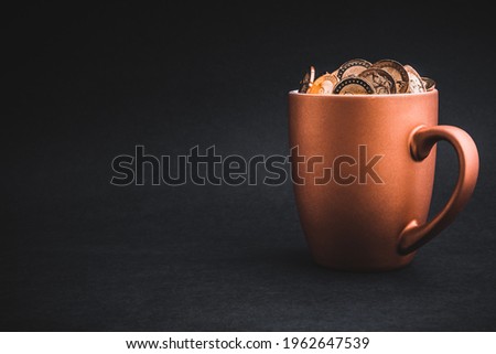 Golden Coins in cups on black background. Tax, Finance, Profit and Investment Concept