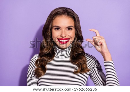 Photo of young cheerful girl happy positive smile show fingers size little small isolated over violet color background