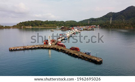 Beautiful high angle view of Bang Bao Pier in Ko Chang District, Trat. There is a white lighthouse at the end of the marina.