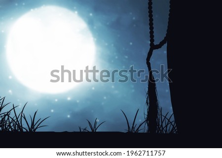 Silhouette of Muslim woman praying with prayer beads on his hands with the night scene background