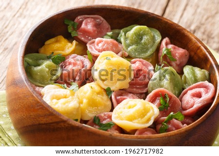 Delicious organic dumplings made from colored dough close-up in a bowl on the table. horizontal
