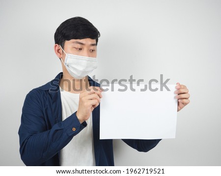 Asian man with mask protect looking at blank paper in his hand on white background