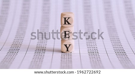KEY sign made of wood on office table on chart