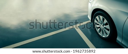 modern car in parking lot, anti slip coating floor for safety, car parked in the right position in modern building carpark area, image with copy space for banner background Royalty-Free Stock Photo #1962735892