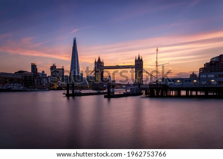 Beautiful long exposure view to the Thames river and skyline of London with Tower Bridge during sunset time, United Kingdom
