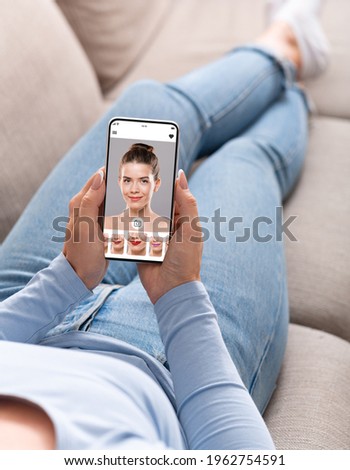 Augmented Reality Beauty App. Over The Shoulder View Of Lady Trying Different Lipstick Color Online On Smartphone, Using Modern Application With AR Makeup Simulation, Creative Collage, Selective Focus